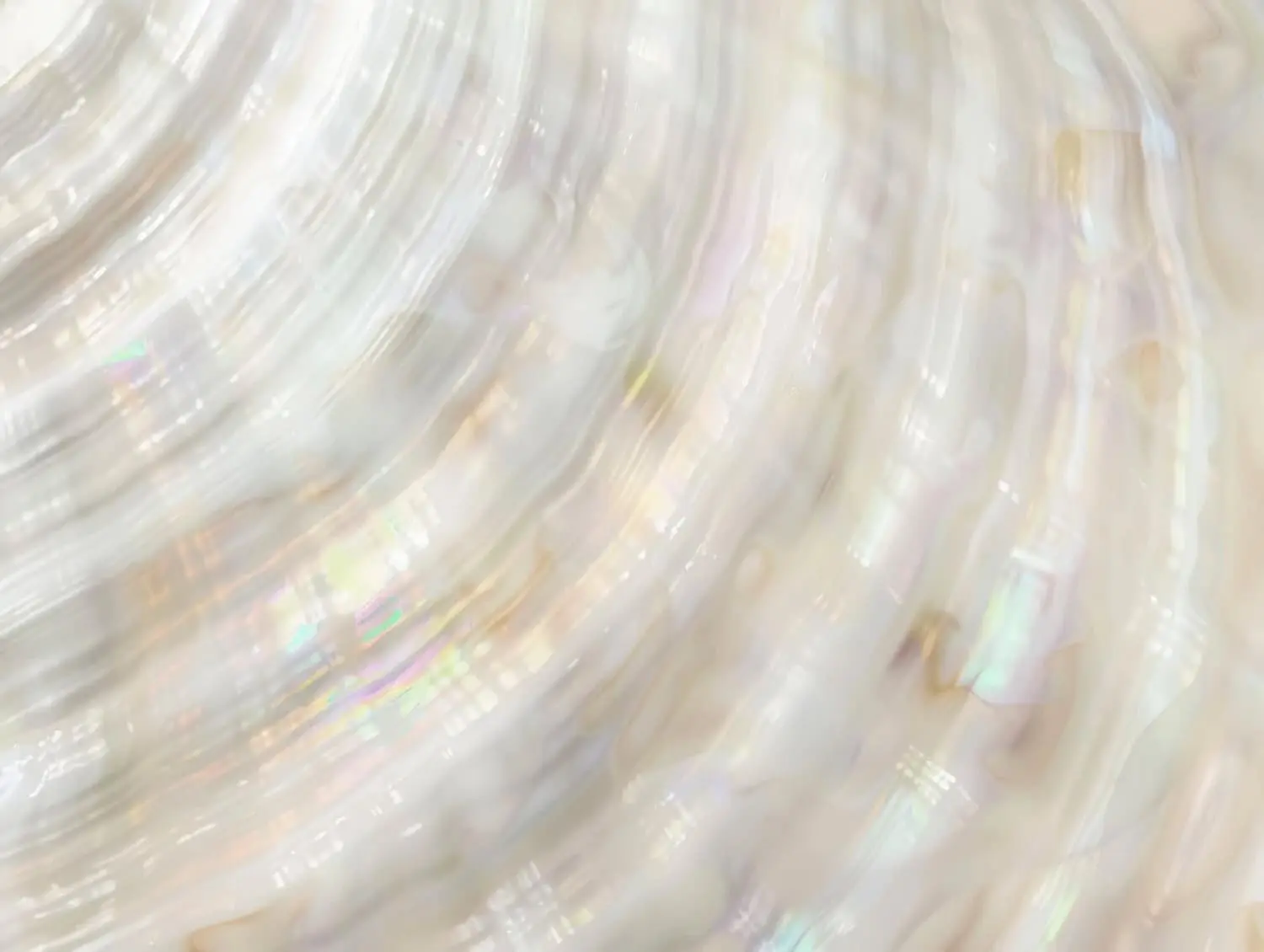 Close-up image of an iridescent, pearlescent surface with swirling, wavy patterns in soft white and pastel colors, echoing the soothing ambiance of Refresh Medspa Best Medical Spa in Cape Coral, FL.