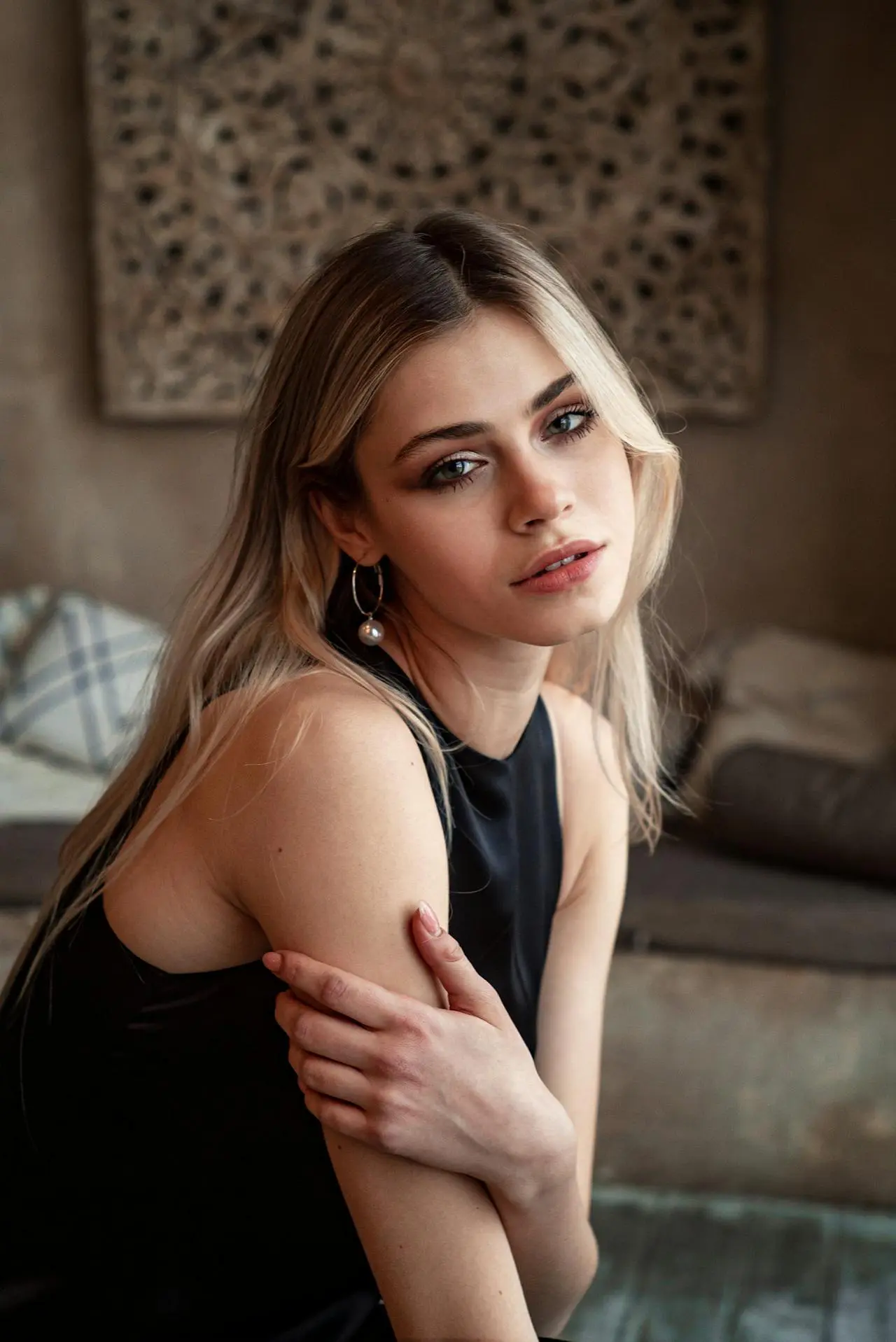 At Refresh MedSpa, a blonde woman with light eyes and smooth skin sits indoors, facing the camera.