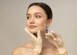 At Refresh MedSpa in Cape Coral, FL, a woman receives a cosmetic injection in her cheek from a gloved professional, highlighting popular Botox alternatives.
