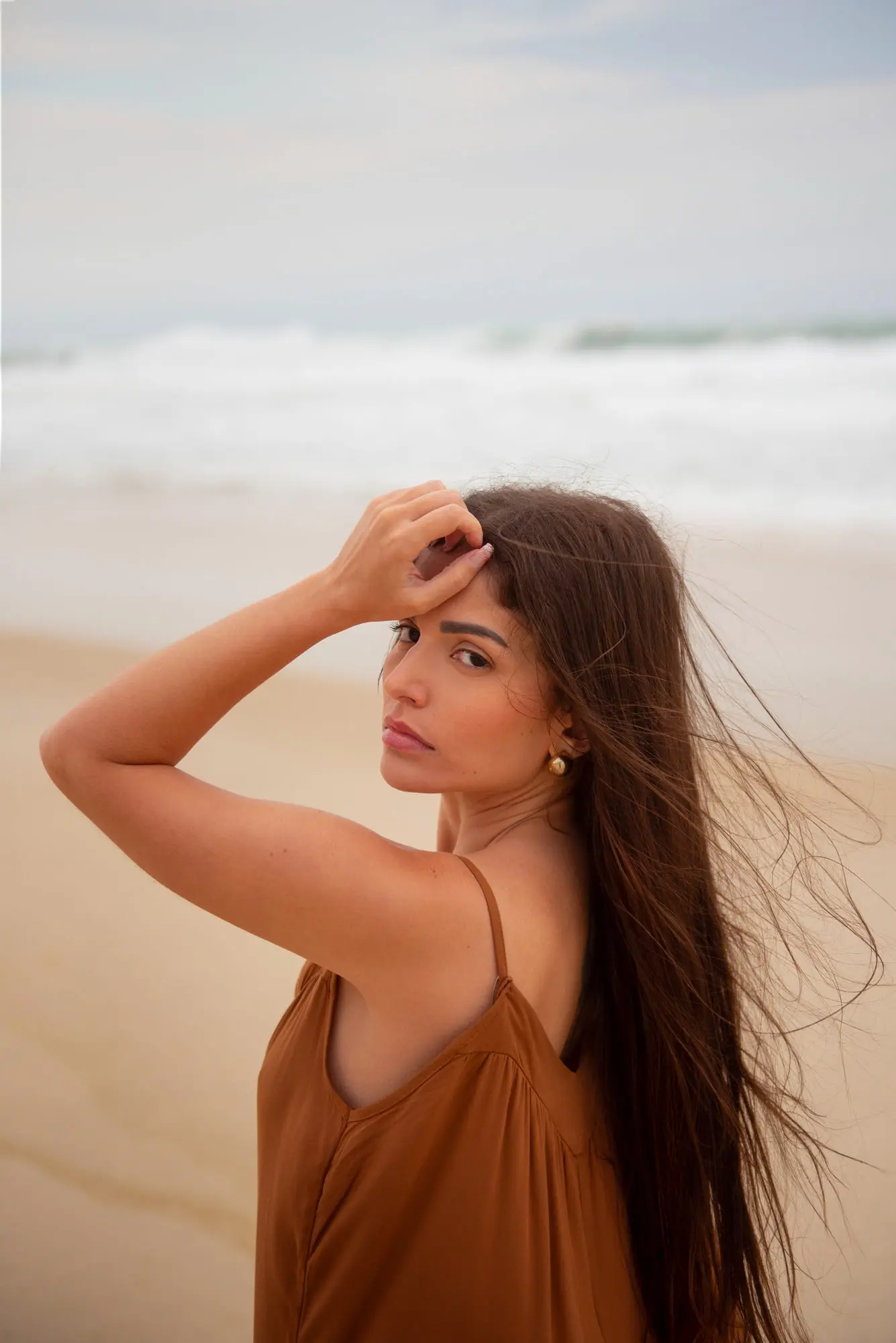 A woman radiates a youthful glow from subtle Botox by Refresh MedSpa as she looks back at the camera.