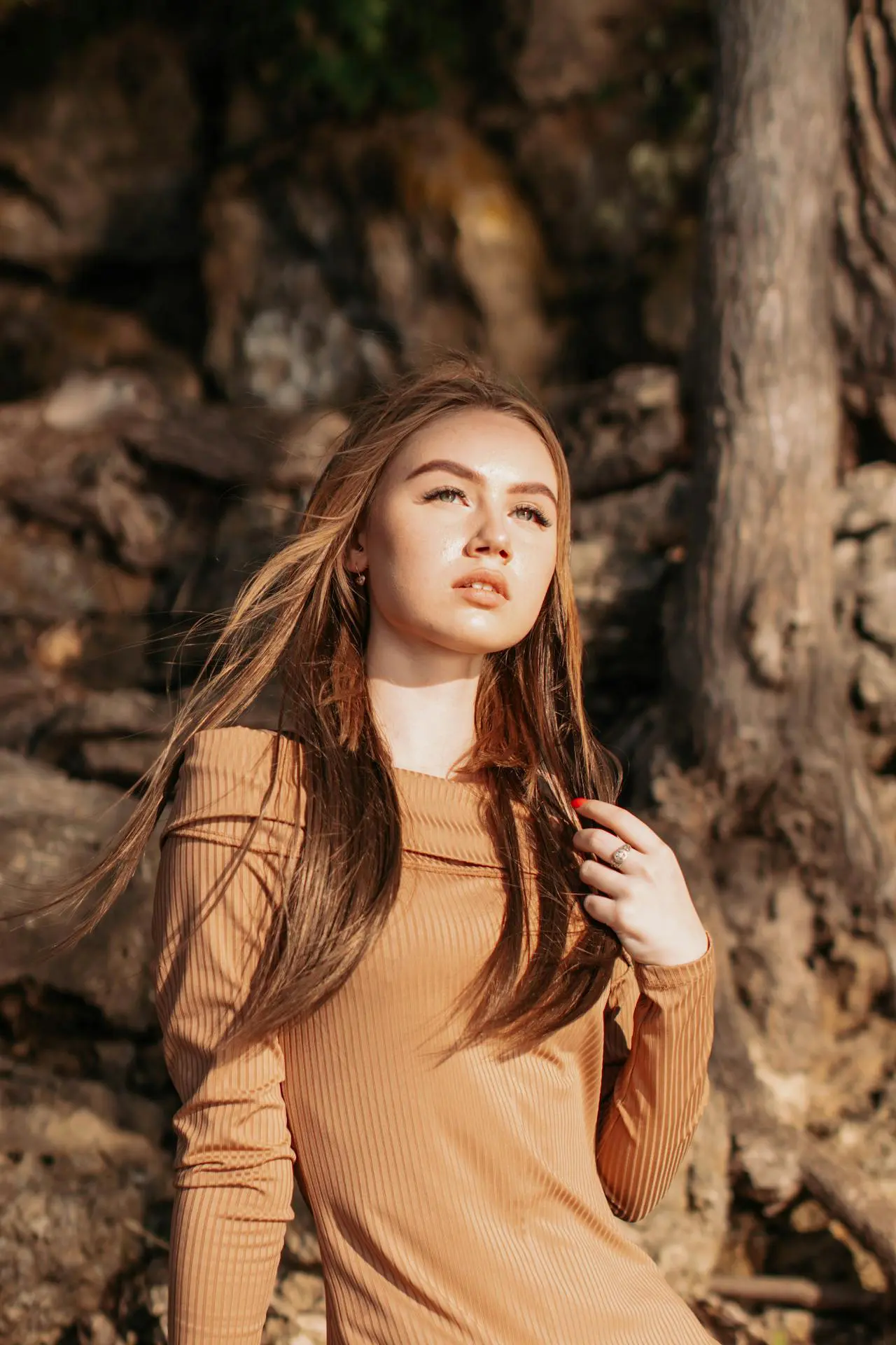 At Refresh MedSpa, a young woman with glowing skin after collagen induction therapy stands outdoors in sunlight.