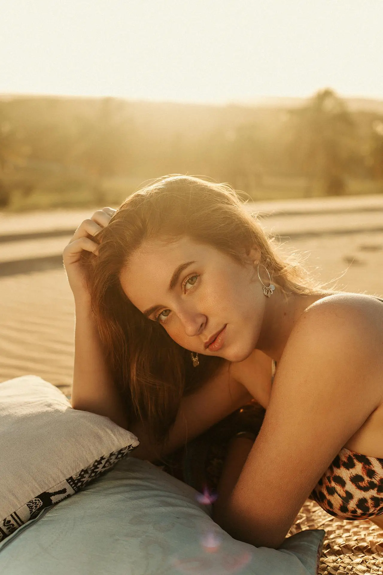 A woman with radiant skin from wrinkle relaxers at Refresh MedSpa reclines and smiles.