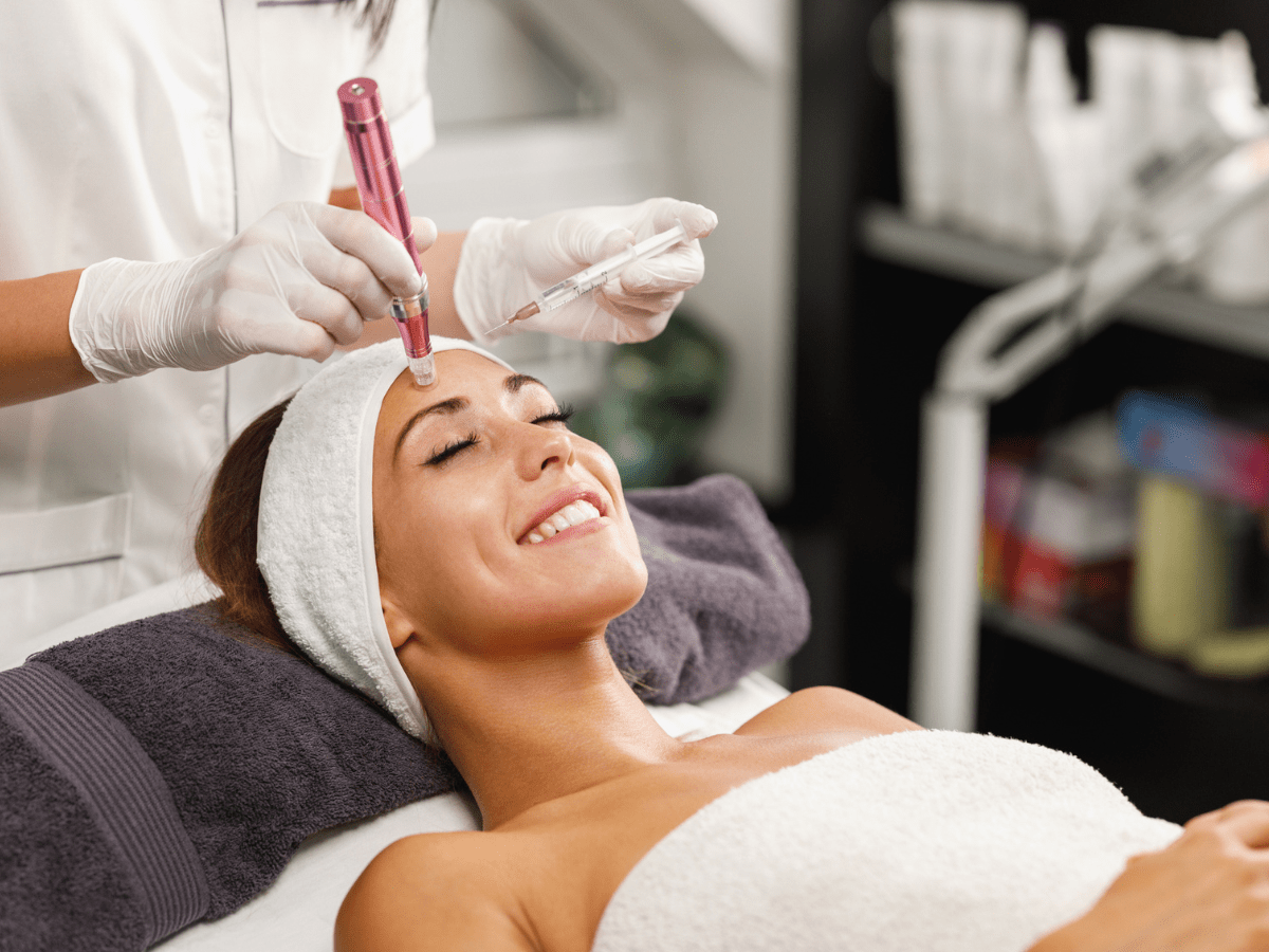 A woman receives microneedling with PRP Therapy at Refresh MedSpa in Cape Coral, FL from a gloved professional.