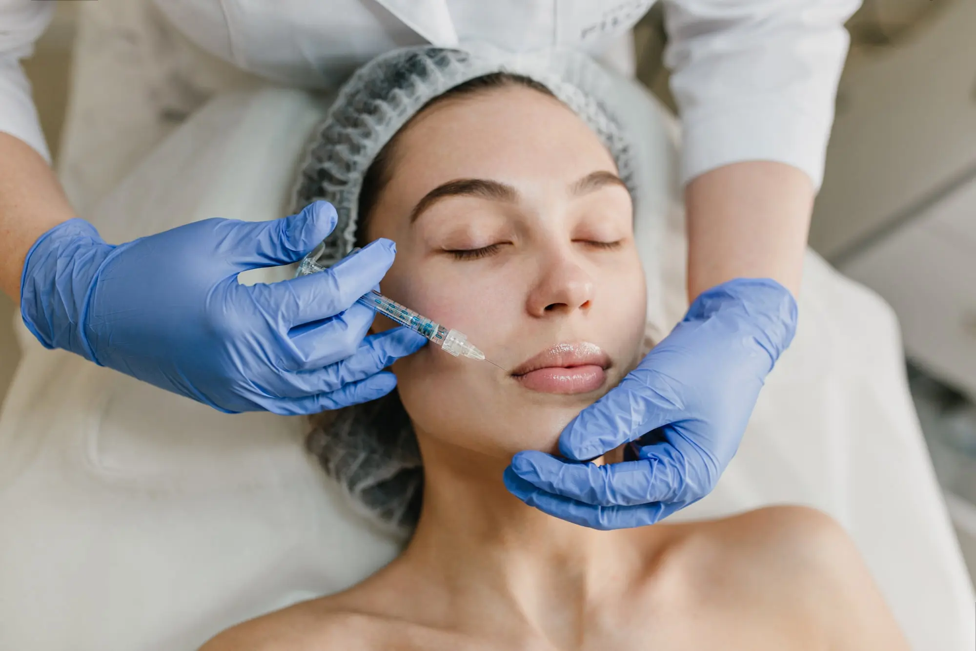 A medical professional in blue gloves administers a botox injection at Refresh MedSpa in Cape Coral, FL.