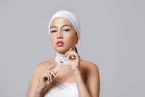 Woman holding a syringe, symbolizing Juvederm dermal filler treatments at Refresh MedSpa in Cape Coral, FL for smooth, youthful, and enhanced facial contours.